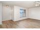 Inviting living room with wood floors and a door leading to a bedroom at 406 S Pebble Beach Blvd, Sun City Center, FL 33573