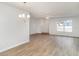 Open living room with wood floors and a view of the backyard at 406 S Pebble Beach Blvd, Sun City Center, FL 33573