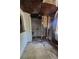 Damaged bathroom area featuring open walls with plumbing for potential upgrades and repairs at 4207 Henry Ave, Tampa, FL 33610