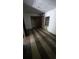 Empty bedroom with damaged walls, wood flooring, closet, and a window offering natural light at 4207 E Henry Ave, Tampa, FL 33610