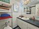 Bathroom featuring a white vanity, countertop, and tiled walls with a towel rack on the left at 504 67Th Ave # 4, St Pete Beach, FL 33706