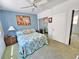 Tranquil bedroom with blue accent wall, floral bedding, and mirrored closet doors at 504 67Th Ave # 4, St Pete Beach, FL 33706