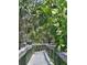Wooden boardwalk through lush greenery leading to scenic views and natural beauty at 504 67Th Ave # 4, St Pete Beach, FL 33706