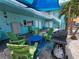 Relaxing outdoor lounge with turquoise building, seating, a blue table, and a grill at 504 67Th Ave # 4, St Pete Beach, FL 33706