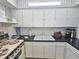 A functional kitchen showcasing laminate countertops, white cabinetry, and a bright workspace at 504 67Th Ave # 4, St Pete Beach, FL 33706