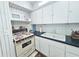 Functional kitchen featuring bright white cabinetry, laminate countertops, and a double basin sink at 504 67Th Ave # 4, St Pete Beach, FL 33706