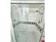 Walk-in shower featuring dual shower heads, black and white tiles, and a built-in bench at 504 67Th Ave # 4, St Pete Beach, FL 33706