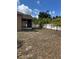 Large backyard with white vinyl fence, palm trees, and covered patio at 5401 Locklear Pl, Riverview, FL 33578