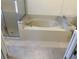 Spacious bathtub with tile surround and glass door access to the shower at 5401 Locklear Pl, Riverview, FL 33578