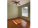 Sunlit bedroom showcases a large window, hardwood floors, and a ceiling fan at 5401 Locklear Pl, Riverview, FL 33578