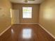 Light-filled bedroom with hardwood floors, a ceiling fan and a window at 5401 Locklear Pl, Riverview, FL 33578