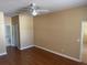 Cozy bedroom featuring laminate floors, a ceiling fan, and access to an ensuite bathroom at 5401 Locklear Pl, Riverview, FL 33578