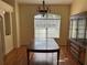 Traditional dining room with hardwood floors, large window and classic chandelier at 5401 Locklear Pl, Riverview, FL 33578