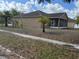 Exterior elevation features desert landscaping, a screened in porch and a side driveway at 5401 Locklear Pl, Riverview, FL 33578