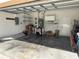 Spacious two car garage with laundry sink, shelving, and overhead lighting at 5401 Locklear Pl, Riverview, FL 33578