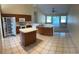 Well-equipped kitchen with island, tile floors, and easy access to the living area at 5401 Locklear Pl, Riverview, FL 33578