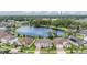 Aerial view of a lakeside community featuring beautiful homes and lush green landscaping at 5416 Camberwell Ln, Riverview, FL 33578