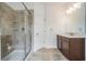 Well-lit bathroom with a glass-enclosed shower, tiled floors, and a modern vanity for a spa-like experience at 5416 Camberwell Ln, Riverview, FL 33578