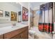 Bathroom featuring vanity with solid surface countertop, tub and shower with a tile surround and whimsical accents at 5416 Camberwell Ln, Riverview, FL 33578