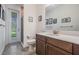Bathroom featuring a vanity with solid surface countertop, framed mirror, and glass enclosed shower at 5416 Camberwell Ln, Riverview, FL 33578