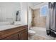 Bathroom featuring vanity with solid surface countertop, tub and shower with a tile surround and window at 5416 Camberwell Ln, Riverview, FL 33578