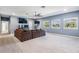 Spacious bonus room with a large sectional sofa, multiple windows, and neutral carpet at 5416 Camberwell Ln, Riverview, FL 33578