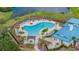 Overhead view of a resort-style community pool, featuring ample seating and lush tropical landscaping at 5416 Camberwell Ln, Riverview, FL 33578