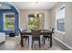 Dining area with natural light, features a dark wood table, seating for four, and backyard views at 5416 Camberwell Ln, Riverview, FL 33578