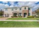 Inviting two-story home featuring stone accents, light blue shutters, and a manicured front lawn at 5416 Camberwell Ln, Riverview, FL 33578