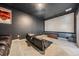 Home theater with large screen, comfortable seating, and modern entertainment setup for immersive viewing experiences at 5416 Camberwell Ln, Riverview, FL 33578