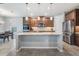 Bright kitchen featuring stainless steel appliances, granite countertops, and island with bar seating at 5416 Camberwell Ln, Riverview, FL 33578