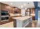 Modern kitchen with granite countertops, stainless steel appliances, and center island at 5416 Camberwell Ln, Riverview, FL 33578