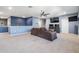 Spacious living room featuring a ceiling fan, entertainment center, and comfortable sofa, perfect for relaxation and entertainment at 5416 Camberwell Ln, Riverview, FL 33578