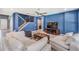Open-concept living room features tile floors, blue walls, and comfortable seating area at 5416 Camberwell Ln, Riverview, FL 33578