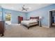 This main bedroom features a ceiling fan, carpet floors, and ample natural light for a comfortable and inviting atmosphere at 5416 Camberwell Ln, Riverview, FL 33578