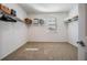 Bright walk-in closet with white walls, carpet, shelving, and window for optimal organization and natural light at 5416 Camberwell Ln, Riverview, FL 33578