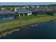 Aerial view of the home showcasing the well-maintained lawn and serene lake at 5547 Silver Sun Dr, Apollo Beach, FL 33572