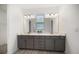 Bathroom featuring a double vanity with gray cabinets and framed mirrors at 5547 Silver Sun Dr, Apollo Beach, FL 33572