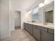 Modern bathroom featuring a double vanity, framed mirrors, and stylish tile flooring at 5547 Silver Sun Dr, Apollo Beach, FL 33572