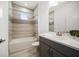 Stylish bathroom with tiled shower and tub, sleek vanity, and modern fixtures at 5547 Silver Sun Dr, Apollo Beach, FL 33572