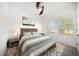 Airy bedroom with large windows, ceiling fan, patterned rug and comfortable, modern furnishings at 5547 Silver Sun Dr, Apollo Beach, FL 33572