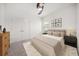 Bright bedroom featuring neutral decor, a ceiling fan, and soft, inviting bedding and carpet at 5547 Silver Sun Dr, Apollo Beach, FL 33572