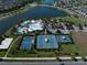 Aerial view featuring the pool, tennis courts, and basketball courts of the community and lake views at 5547 Silver Sun Dr, Apollo Beach, FL 33572