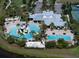 An aerial view shows the multiple pools, waterslide, lounge areas, and lush landscaping of the community at 5547 Silver Sun Dr, Apollo Beach, FL 33572