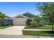 Charming single-story home with a two-car garage, well-kept lawn, and beautiful landscaping at 5547 Silver Sun Dr, Apollo Beach, FL 33572