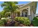 Charming front porch with stone pillars and lush landscaping offering curb appeal at 5547 Silver Sun Dr, Apollo Beach, FL 33572