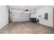Spacious garage with a roll-up door, ample storage space, and concrete flooring at 5547 Silver Sun Dr, Apollo Beach, FL 33572