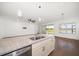 Kitchen island featuring granite countertops, a double sink, and stainless steel dishwasher at 5547 Silver Sun Dr, Apollo Beach, FL 33572