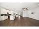 Open floor plan with modern kitchen, stainless appliances, hardwood floors, and ceiling fan at 5547 Silver Sun Dr, Apollo Beach, FL 33572