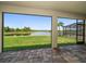 Spacious screened patio offering serene views of the pond, complemented by lovely stone flooring at 5547 Silver Sun Dr, Apollo Beach, FL 33572